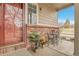Charming front porch with brick accents, an ornate door, and lovely outdoor seating at 14944 E Archer Cir, Aurora, CO 80012