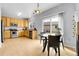 Bright kitchen with stainless steel appliances, wood-look laminate flooring, and sliding glass door at 14944 E Archer Cir, Aurora, CO 80012