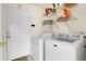 Functional laundry room with washer, dryer, and shelving for storage at 14944 E Archer Cir, Aurora, CO 80012
