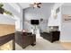 Bright living room with vaulted ceilings and fireplace is open to other living spaces at 14944 E Archer Cir, Aurora, CO 80012