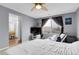 Spacious bedroom features a ceiling fan, neutral paint, and natural light at 14944 E Archer Cir, Aurora, CO 80012