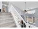 Carpeted staircase offers safe passage between floors, enhancing access to upper levels at 14944 E Archer Cir, Aurora, CO 80012