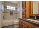 Bright bathroom featuring tiled shower-tub, decorative accents, and wood vanity at 9784 W Euclid Dr, Littleton, CO 80123