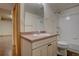 Cozy bathroom with a mirrored vanity, and combined shower and tub at 9784 W Euclid Dr, Littleton, CO 80123