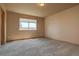 Cozy bedroom featuring neutral carpet, a large window letting in lots of light, and neutral wall colors at 9784 W Euclid Dr, Littleton, CO 80123