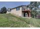 Backyard view of a home with a wood deck and lush green grass at 9784 W Euclid Dr, Littleton, CO 80123