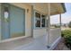 View of the blue front door and small porch with white railing at 9784 W Euclid Dr, Littleton, CO 80123