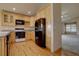 Spacious kitchen featuring wood floors, stainless steel appliances, and ample cabinet space at 9784 W Euclid Dr, Littleton, CO 80123