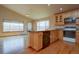 Kitchen features warm wood cabinets, black appliances, and hardwood floors at 9784 W Euclid Dr, Littleton, CO 80123