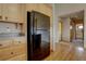 Spacious kitchen with warm wood cabinets and black refrigerator at 9784 W Euclid Dr, Littleton, CO 80123