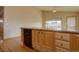 Kitchen featuring light wood cabinets, stainless steel appliances, and a large island at 9784 W Euclid Dr, Littleton, CO 80123