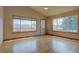 Bright living area featuring wood floors and multiple large windows at 9784 W Euclid Dr, Littleton, CO 80123