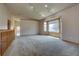 Bright living room featuring neutral carpet, bay window, and vaulted ceilings with modern track lighting at 9784 W Euclid Dr, Littleton, CO 80123