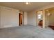 Spacious main bedroom featuring fresh carpet, neutral walls, and doorways leading to the ensuite bathroom and walk-in closet at 9784 W Euclid Dr, Littleton, CO 80123