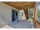 Outdoor patio with a sliding glass door, natural light, and wood beam ceiling at 9784 W Euclid Dr, Littleton, CO 80123