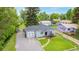 This home features a gravel driveway and a well-manicured front yard with stepping stone path leading to the front door at 8450 W 13Th St, Lakewood, CO 80215