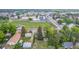 Aerial view showcases property with mature trees, landscaping, and proximity to community park, playground, and green space at 8450 W 13Th St, Lakewood, CO 80215