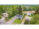 This home features a charming front yard with gravel driveway and mature trees providing shade and privacy at 8450 W 13Th St, Lakewood, CO 80215