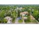 Aerial view showcases property with mature trees, landscaping, and proximity to green space and other homes at 8450 W 13Th St, Lakewood, CO 80215
