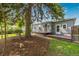 Back of the home, showing a wooden deck and a large tree at 8450 W 13Th St, Lakewood, CO 80215