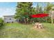 Expansive backyard featuring a unique tree-stump table with a bright red umbrella, perfect for outdoor enjoyment at 8450 W 13Th St, Lakewood, CO 80215