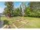 Spacious backyard featuring wooden planting beds and mature trees at 8450 W 13Th St, Lakewood, CO 80215