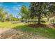 Large backyard with mature trees, a shed, and a fenced area at 8450 W 13Th St, Lakewood, CO 80215