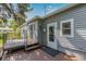 Backyard showcasing a wooden deck and the home's gray exterior at 8450 W 13Th St, Lakewood, CO 80215