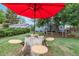 Inviting backyard featuring a stump table with umbrella and wooden chairs at 8450 W 13Th St, Lakewood, CO 80215