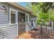 Home's back entry featuring a wooden deck and gray horizontal siding at 8450 W 13Th St, Lakewood, CO 80215