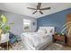 A spacious bedroom with hardwood floors, blue accent wall, and a large window at 8450 W 13Th St, Lakewood, CO 80215