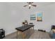 Bright bonus room features neutral walls, ceiling fan, modern vinyl flooring, and an exam table at 8450 W 13Th St, Lakewood, CO 80215