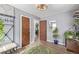 An inviting hallway with plants, mirrors, and multiple doors leading to different rooms at 8450 W 13Th St, Lakewood, CO 80215