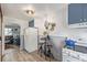 Compact kitchen featuring blue cabinets, stainless appliances, and a casual dining area at 8450 W 13Th St, Lakewood, CO 80215