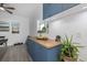 Stylish kitchenette featuring custom blue cabinets, wooden countertop, updated faucet, and modern decor at 8450 W 13Th St, Lakewood, CO 80215