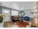 Cozy living room featuring stylish furnishings, wood-look floors, and lots of natural light at 8450 W 13Th St, Lakewood, CO 80215