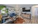 Comfortable living room featuring stylish furnishings, wood-look floors, and lots of natural light at 8450 W 13Th St, Lakewood, CO 80215