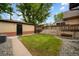 Backyard with detached garage/shed featuring mature trees and landscaping. Plenty of room for outdoor entertaining at 1243 Monroe St, Denver, CO 80206