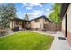 This home features a large backyard with a covered patio and an expansive lawn, great for entertaining at 1243 Monroe St, Denver, CO 80206