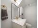 The bathroom has a modern vanity with marble countertop, gold hardware, and stylish mirror at 1243 Monroe St, Denver, CO 80206