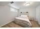 The bedroom features a wood headboard, neutral bedding, and carpeted floors at 1243 Monroe St, Denver, CO 80206