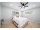 Bright bedroom features hardwood floors, ceiling fan, and sun-filled windows at 1243 Monroe St, Denver, CO 80206