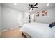 Cozy bedroom features hardwood floors, ceiling fan, ensuite laundry, and natural light at 1243 Monroe St, Denver, CO 80206