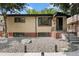 Traditional-style home with a brick facade, decorative rock landscaping, and covered front porch at 1243 Monroe St, Denver, CO 80206