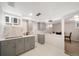 This kitchen features gray cabinets with quartz countertops and herringbone tile backsplash at 1243 Monroe St, Denver, CO 80206
