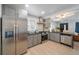 Bright kitchen with stainless steel appliances, gas range, gray cabinets, and hardwood floors at 1243 Monroe St, Denver, CO 80206