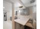 The newly renovated kitchen has gray cabinets, sleek countertops, and stylish lighting fixtures at 1243 Monroe St, Denver, CO 80206
