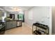 Open concept kitchen featuring stainless steel dishwasher, gas range, and bar cart at 1243 Monroe St, Denver, CO 80206
