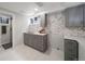 The kitchen has gray cabinets with gold hardware, quartz countertops, and herringbone tile backsplash at 1243 Monroe St, Denver, CO 80206