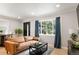 Comfortable living room with neutral color scheme, modern sofa, recessed lighting, and window overlooking greenery at 1243 Monroe St, Denver, CO 80206